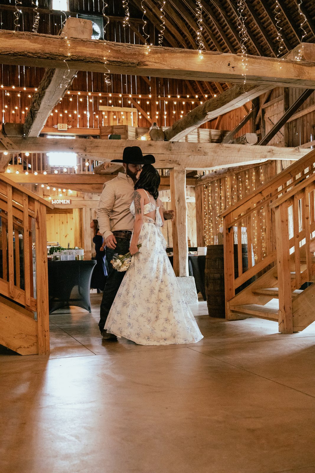 Bride and groom during their first dance in a barn